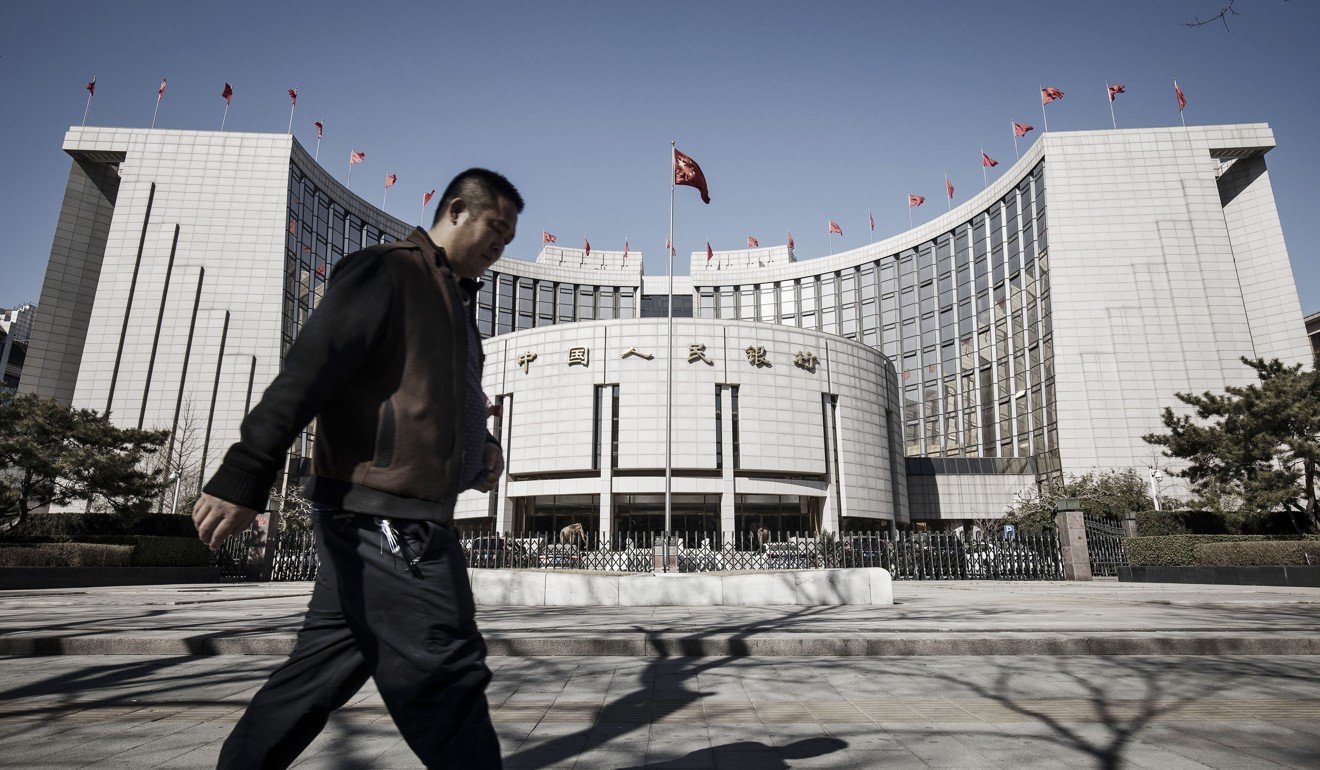 A man walks past the People's Bank of China headquarters in Beijing in March. Photo: Bloomberg