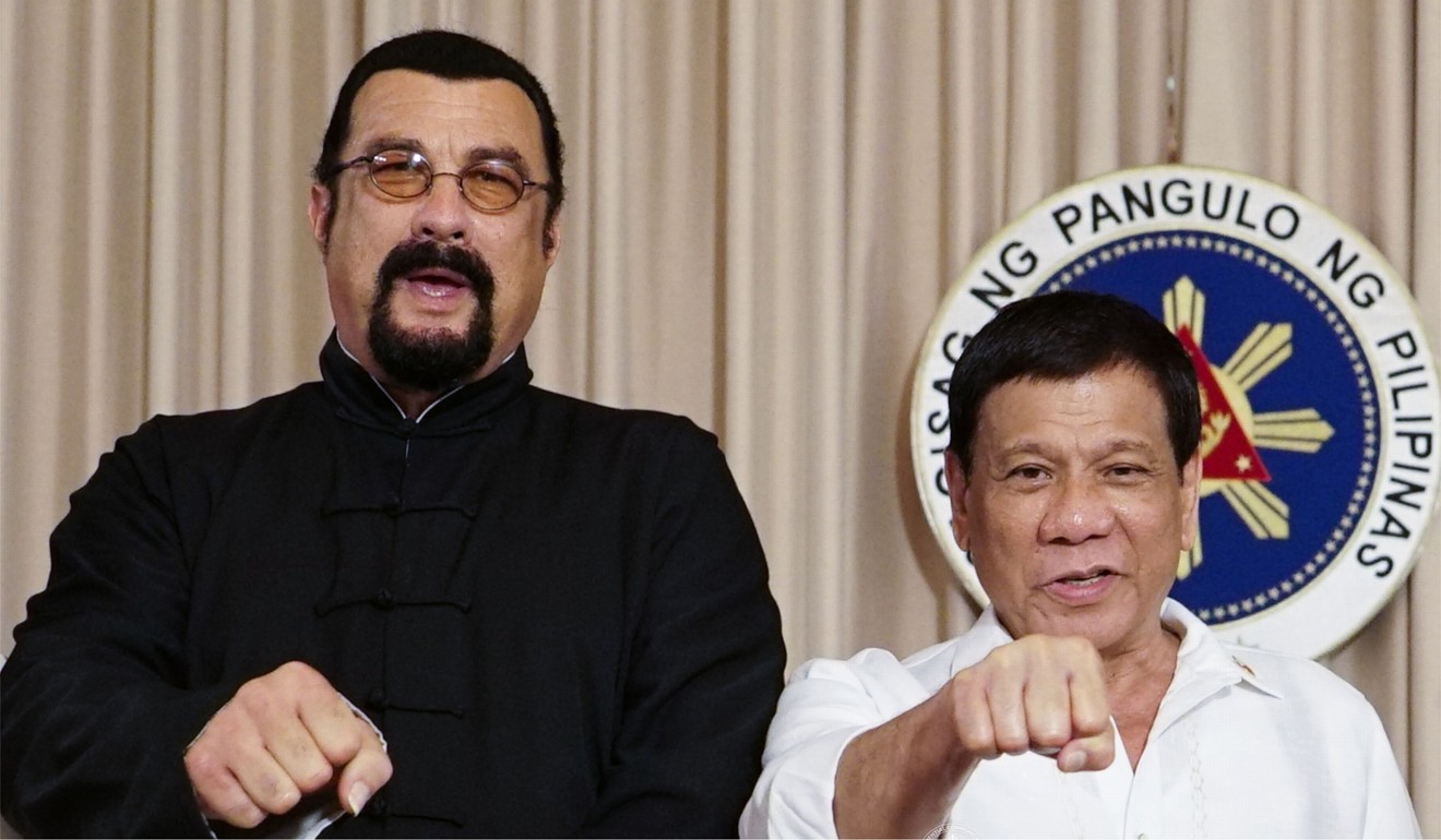 Seagal and Duterte posing for the press at Malacanang Palace in Manila. Photo: AFP