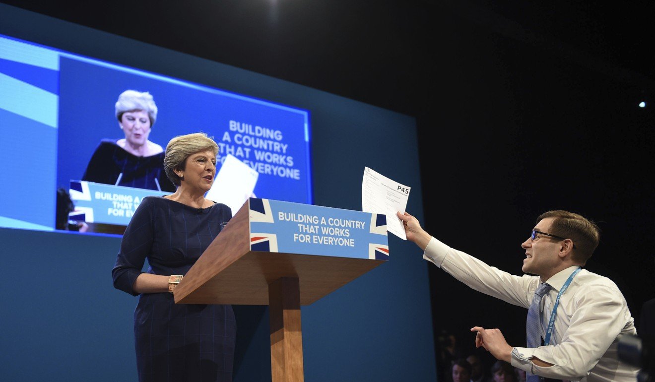 Comedian Simon Brodkin confronts British Prime Minister Theresa May during her keynote speech. Photo: AP