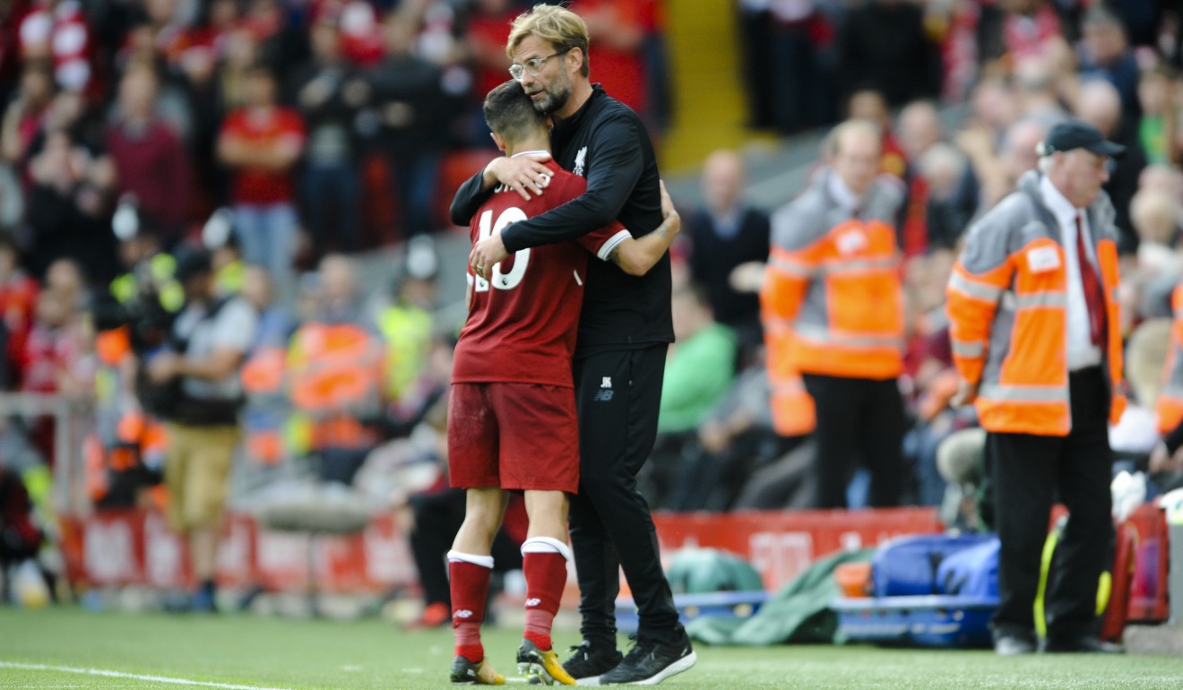 Liverpool coach Juergen Klopp embraces Philippe Coutinho. Photo: AP