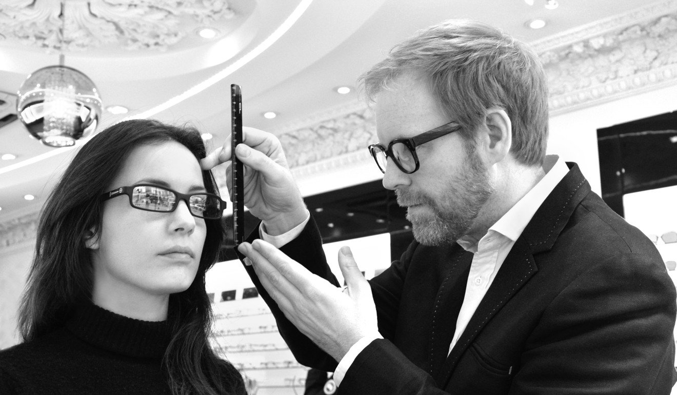 Tom Davies measures up a client. Bespoke glasses fit comfortably on the face because all the details are taken into consideration.
