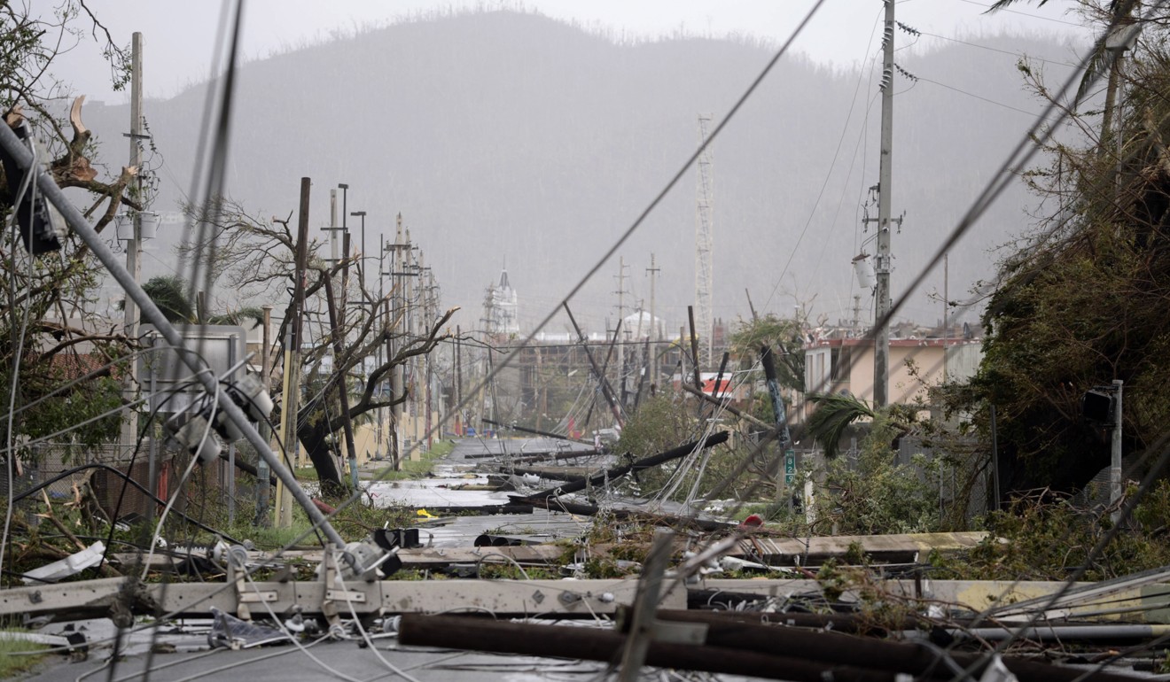 This September 20, 2017 file photo shows smashed poles and snarled power lines brought down by Hurricane Maria, in Humacao, Puerto Rico. A month later, 80 per cent of the island remained without power. Photo: AP