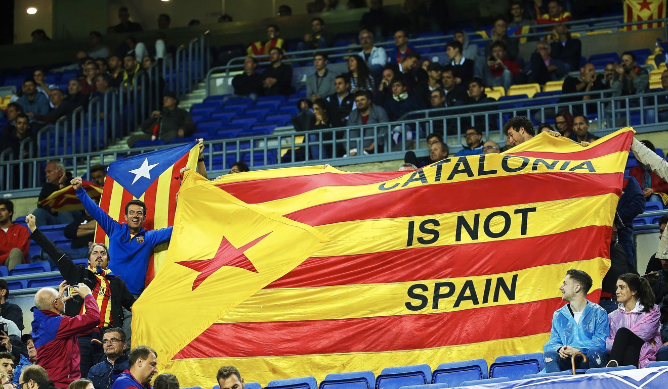 Barcelona football fans display a Catalan independence flag during their team’s match against Olympiacos at the Nou Camp in Barcelona on October 18. Photo: EPA-EFE