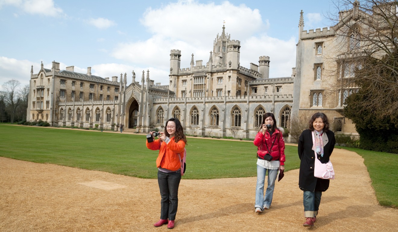 Tourists take photos outside St Johns College at Cambridge University. Photo: Alamy