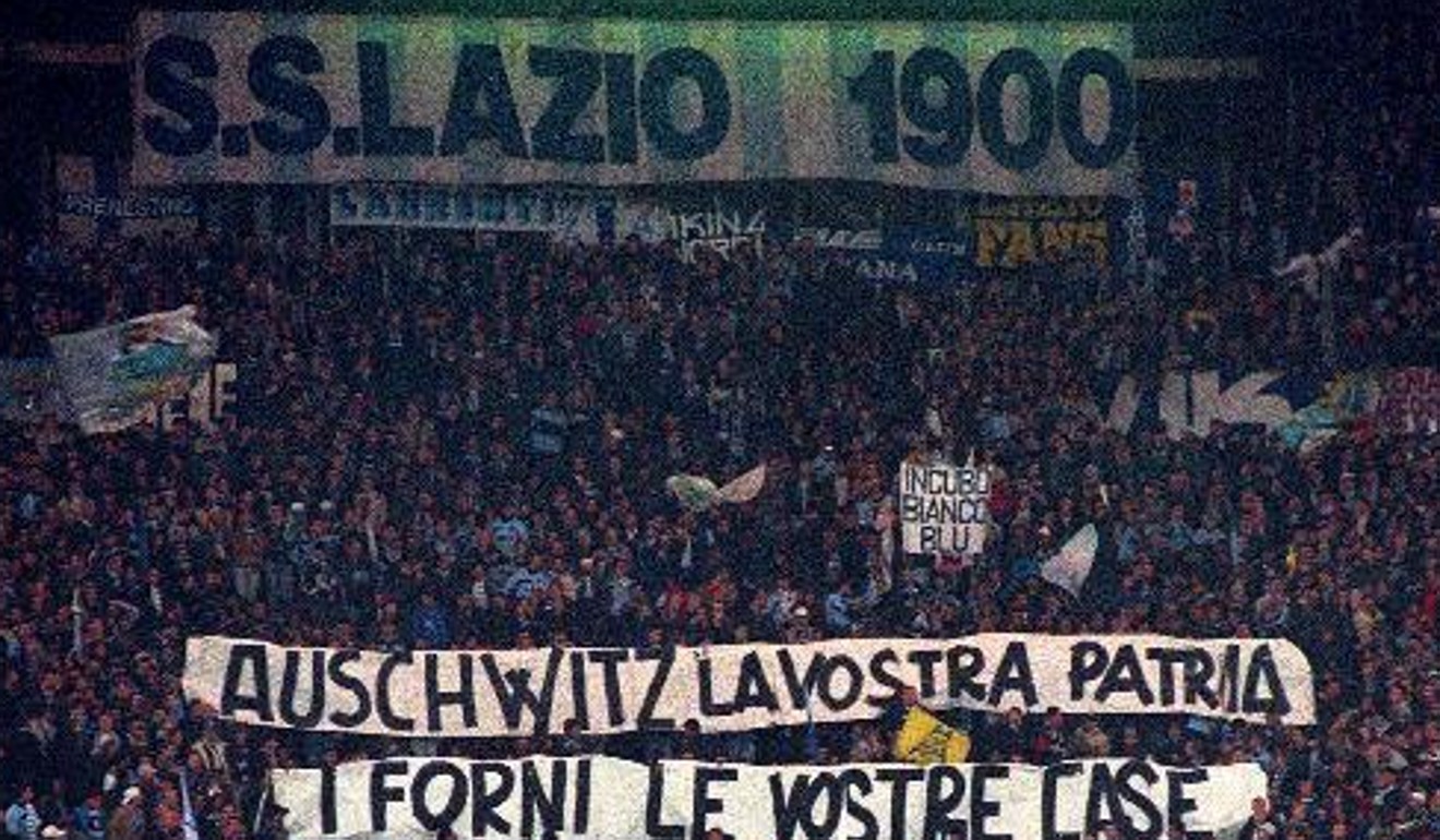 In this 1998 file photo, Lazio fans display banners from the stands reading ‘Auschwitz is Your Homeland. The Ovens are Your Homes’ during a Serie A match against Roma. Photo: AP