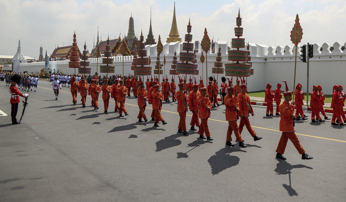 Thai royal military officers march past the Grand Palace during the procession to transfer the royal relics and ashes. Photo: EPA