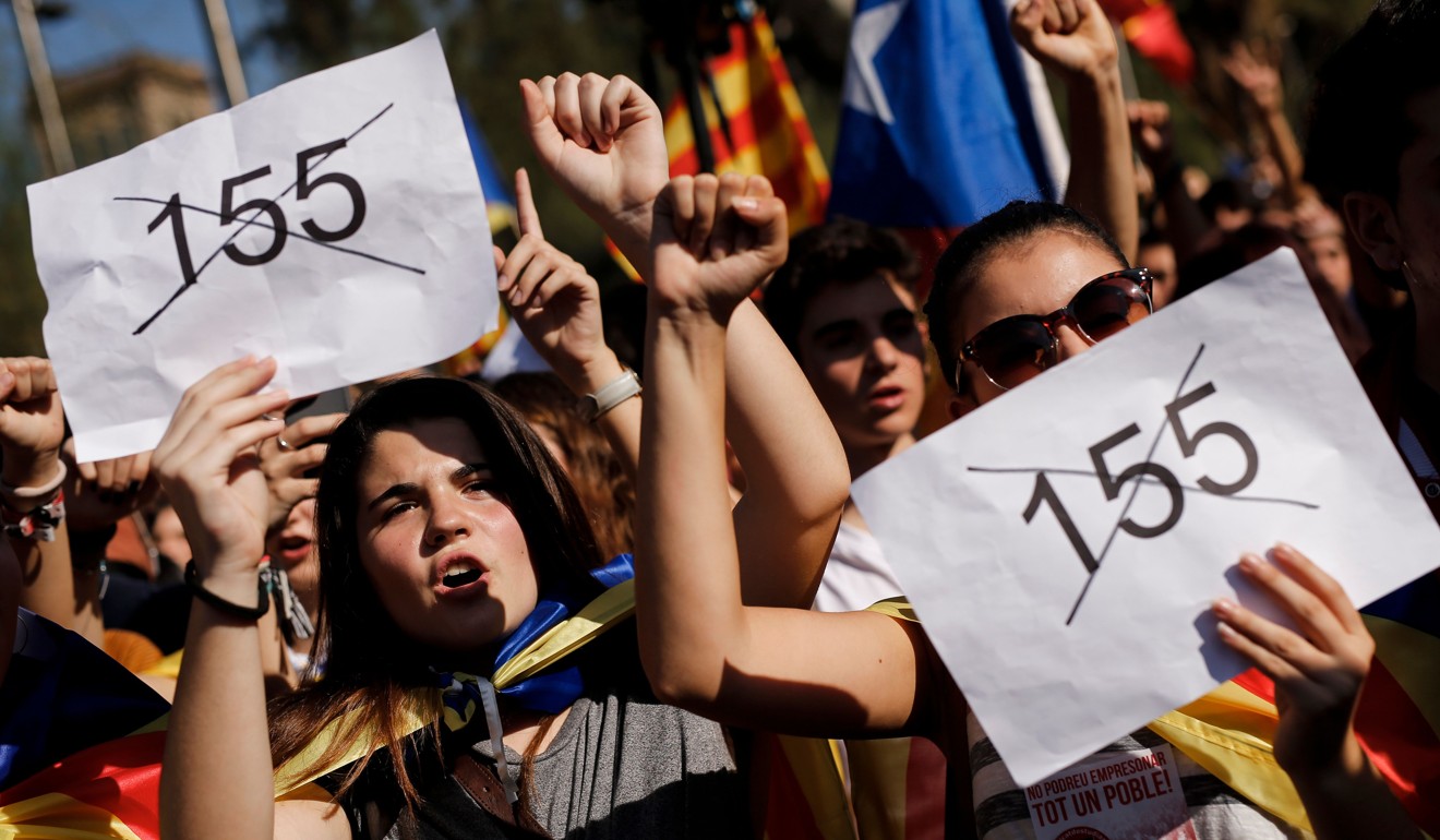 Students hold papers against Article 155 of the Spanish constitution during a demonstration in Barcelona on October 26, 2017. Thousands of students rallied in Barcelona in support of Catalan independence. Photo: Agence France-Presse
