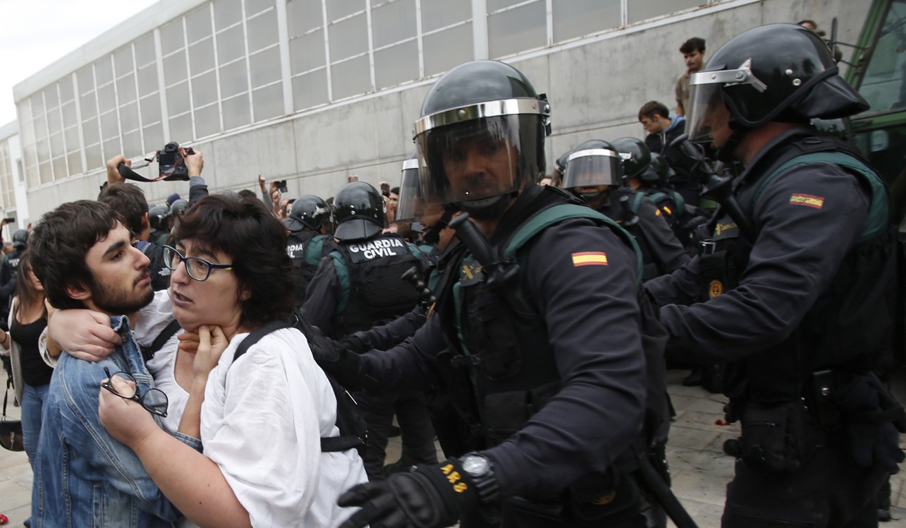 Civil guards push people away the entrance of a sports centre where people were voting in the October 1 Catalan independence referendum in Girona on October 1. Photo: AP