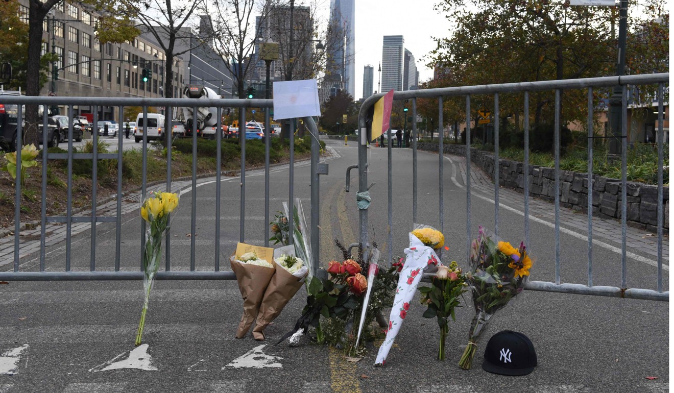 People stop at a memorial on Wednesday near the site of the previous day's terror attack in New York. Photo: AFP