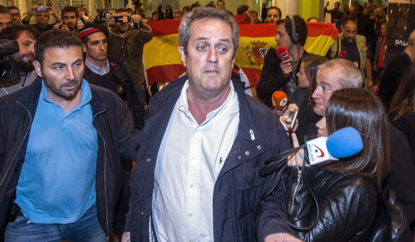Dismissed Catalan regional Minister for Homme Affairs Joaquim Forn (centre) is surrounded by the media as he returns from Brussels, Belgium, to the Barcelona-El Prat airport.Photo: EPA