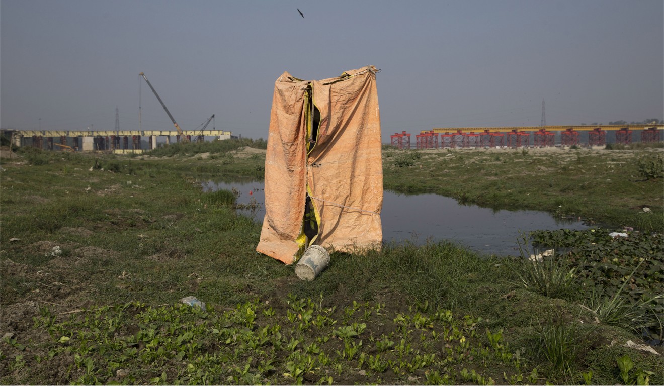 A temporary toilet made by farmers near the River Yamuna in New Delhi, India. Photo: AP