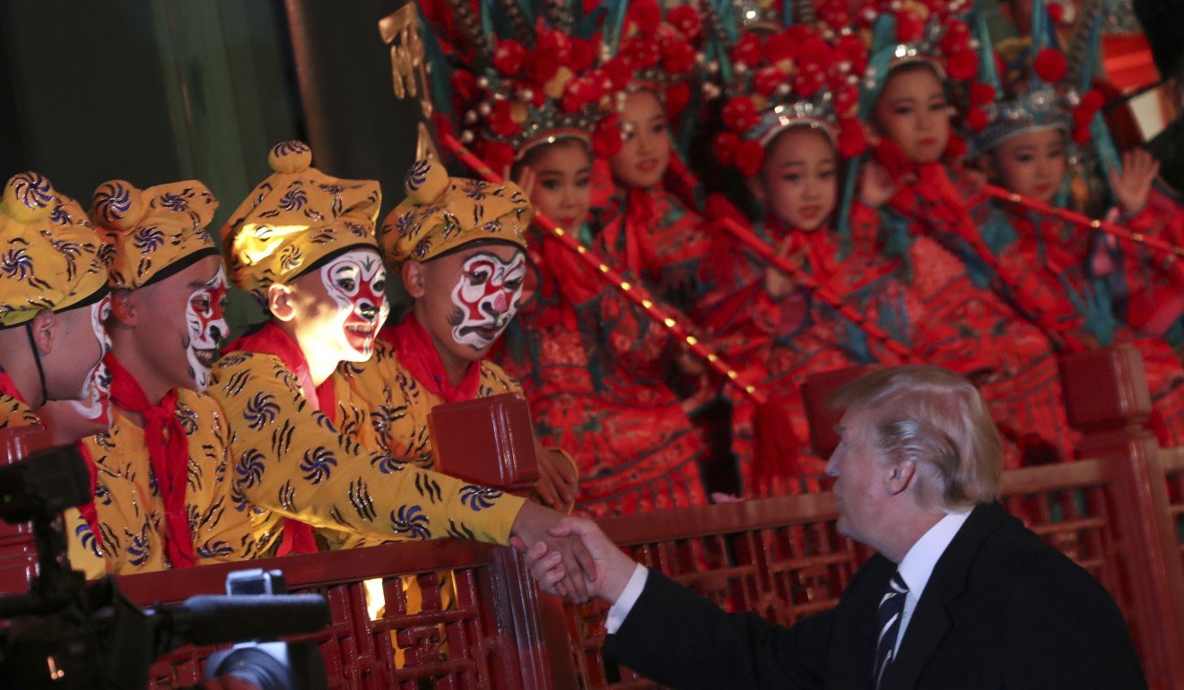Donald Trump talks to opera performers, accompanied by Chinese President Xi Jinping, at the Forbidden City. Photo: AP