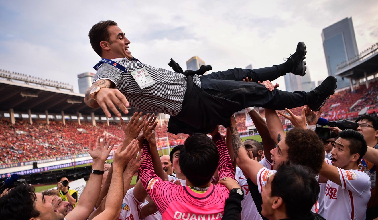 Tianjin Quanjian players give head coach Fabio Cannavaro the ‘bumps’ as they celebrate a win against Guangzhou Evergrande. Photo: AFP