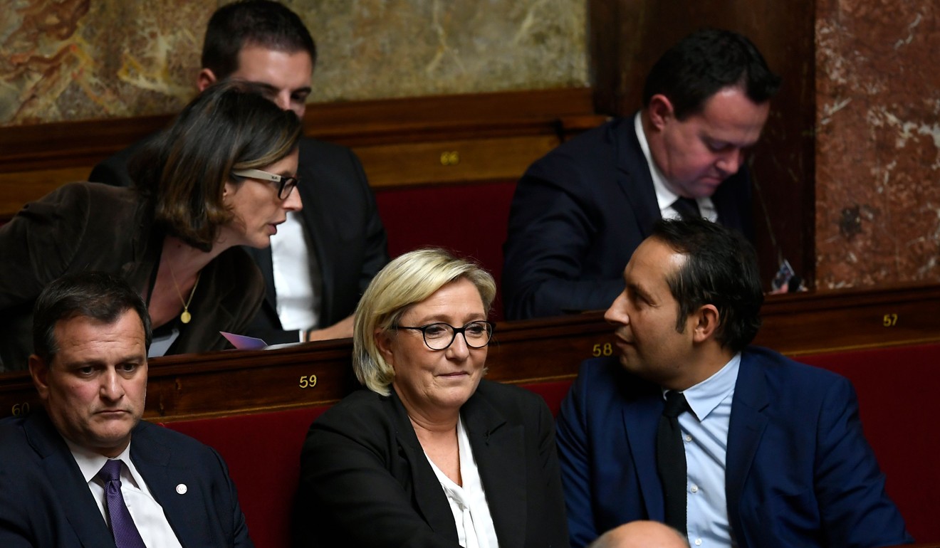 French far-right Front National (FN) party members of Parliament Louis Aliot (L) and FN president Marine Le Pen (C) attend a session at the French National Assembly in Paris. Photo: Agence France-Presse