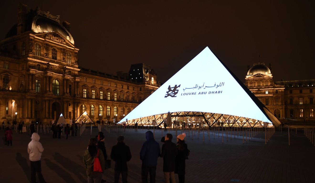 Images are projected onto the Louvre Pyramid in Paris at night on November 8, 2017, to mark the opening of the Louvre Abu Dhabi Museum. Photo: Agence France-Presse