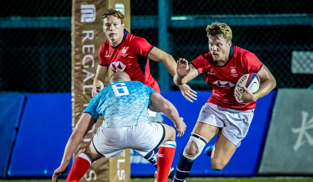 Hong Kong’s Matt Rosslee attempts to run the ball from deep in defence.