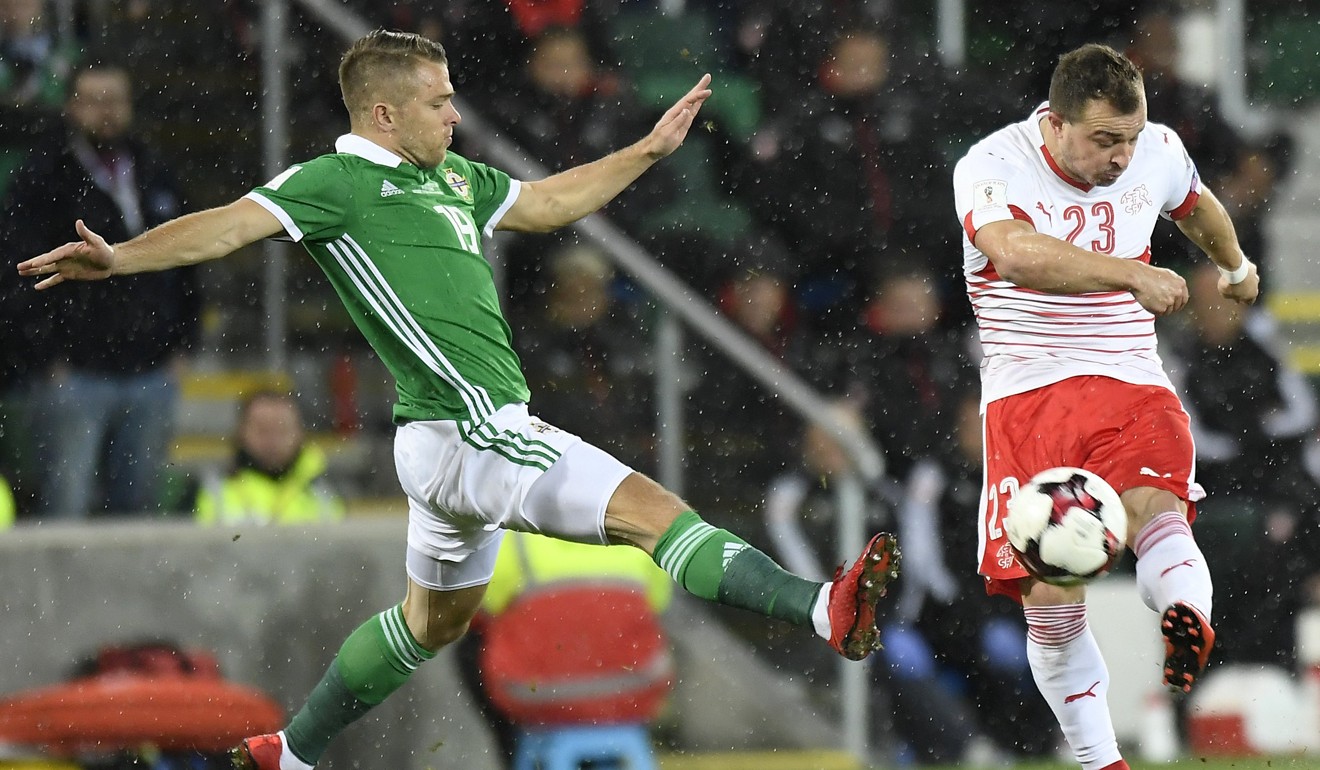 Northern Ireland's Jamie Ward (left) fights for the ball with Switzerland's Xherdan Shaqiri. Photo: EPA