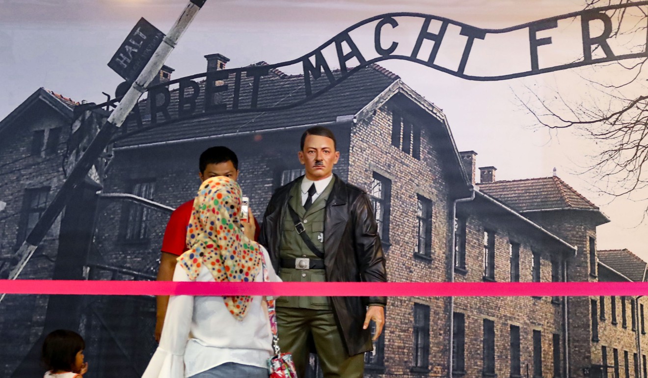 An Indonesian family taking photos with the Hitler model at the museum in Yogyakarta. Photo: AFP