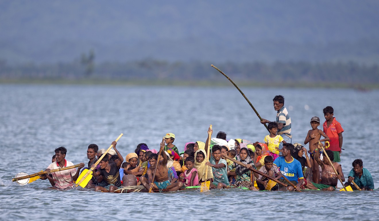 Rohingya Muslims travel on a makeshift raft over the Naf river into Bangladesh. Photo: AP