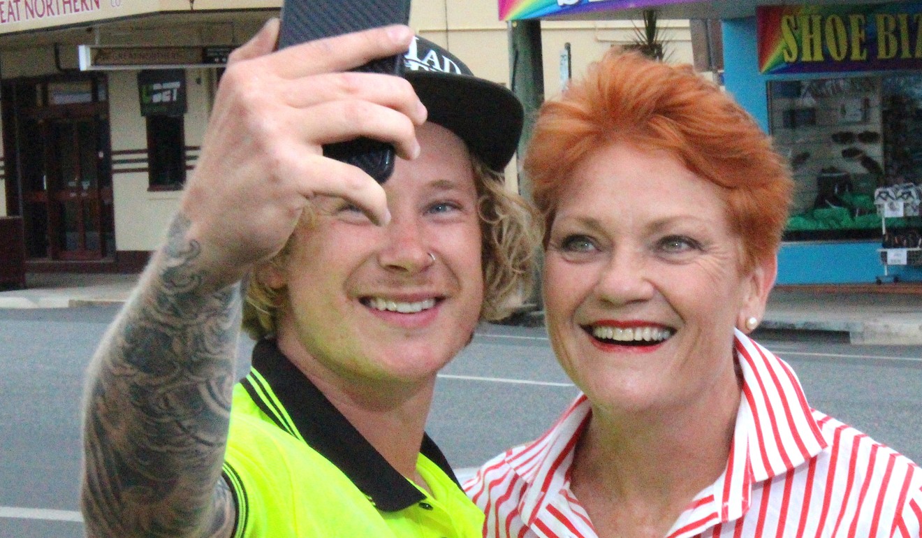Pauline Hanson takes a photo with supporter Brodie Tophan in the town of Proserpine, Queensland, Australia. Photo: Reuters