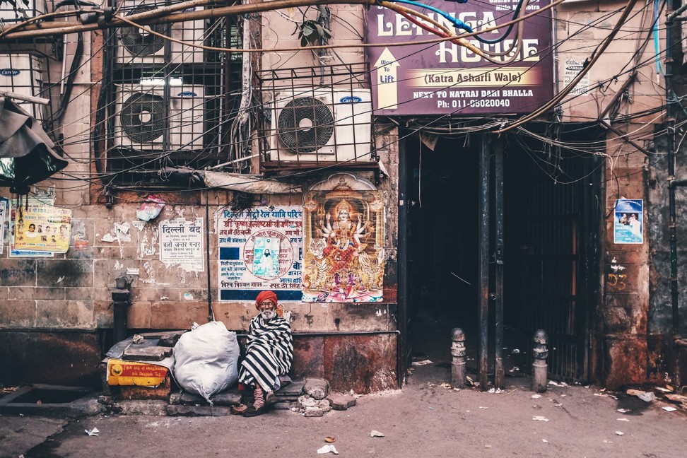 An old man sits in the street in India. Photo: Aik Beng Chia