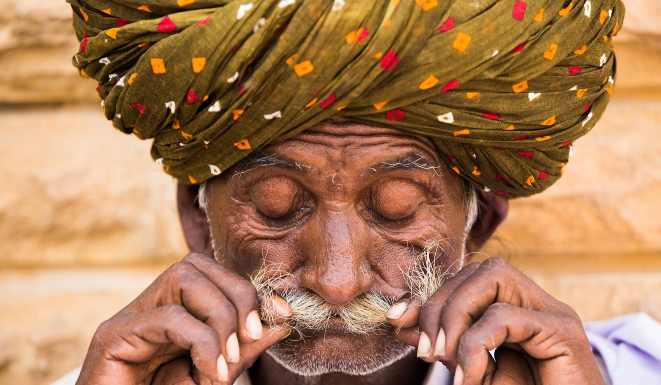 This photo of a Rajasthani man preparing his moustache was taken in Jaisalmer, India. “It is the photo before the pose!” Photo: Rehahn