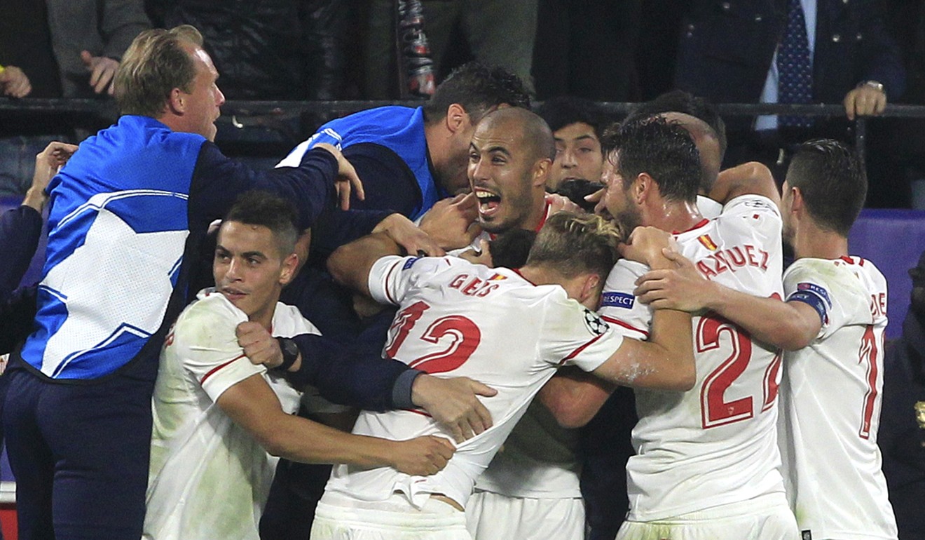 Sevilla players celebrate after Guido Pizarro (centre) scores an added-time equaliser. Photo: AP