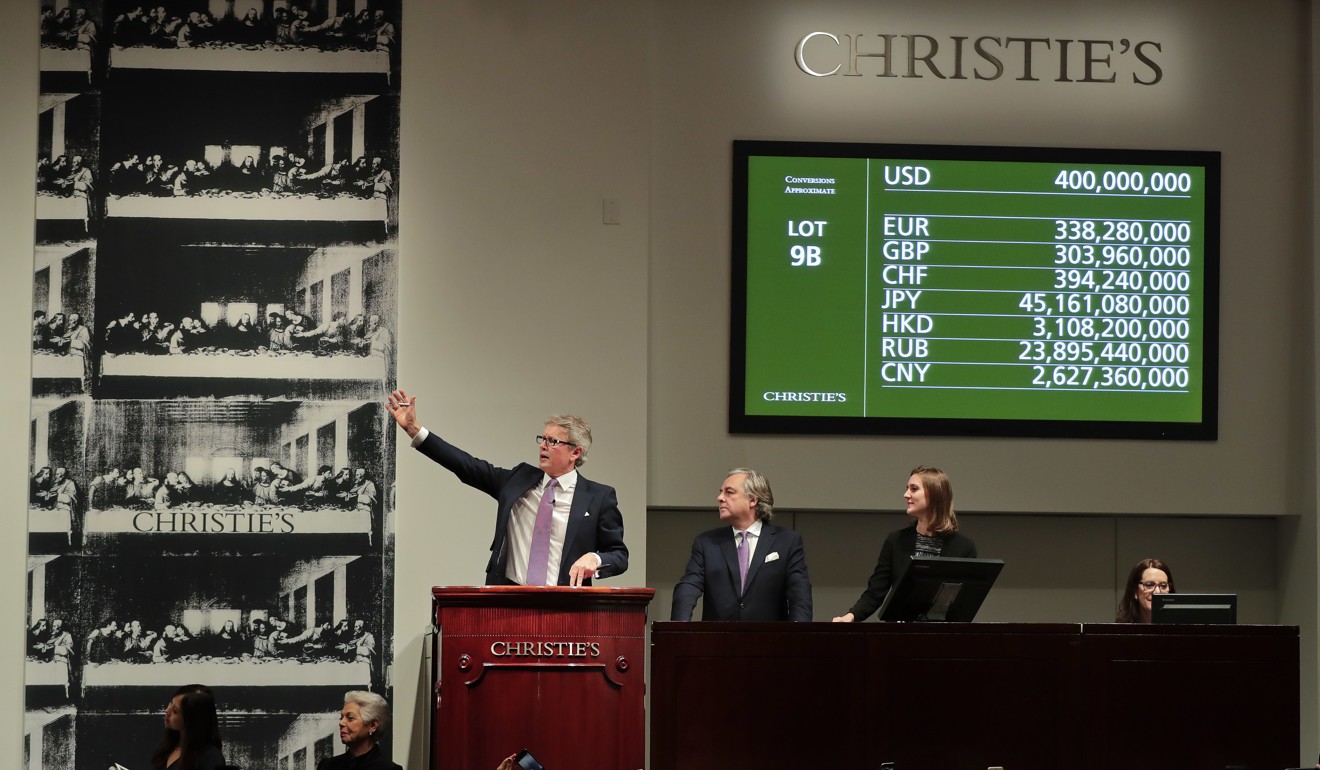 Christie's auctioneer Jussi Pylkannen (left) looks for one last bid for Leonardo da Vinci's Salvator Mundi at the Christie's auction in New York this month. The painting sold for US$450 million including fees. Photo: AP
