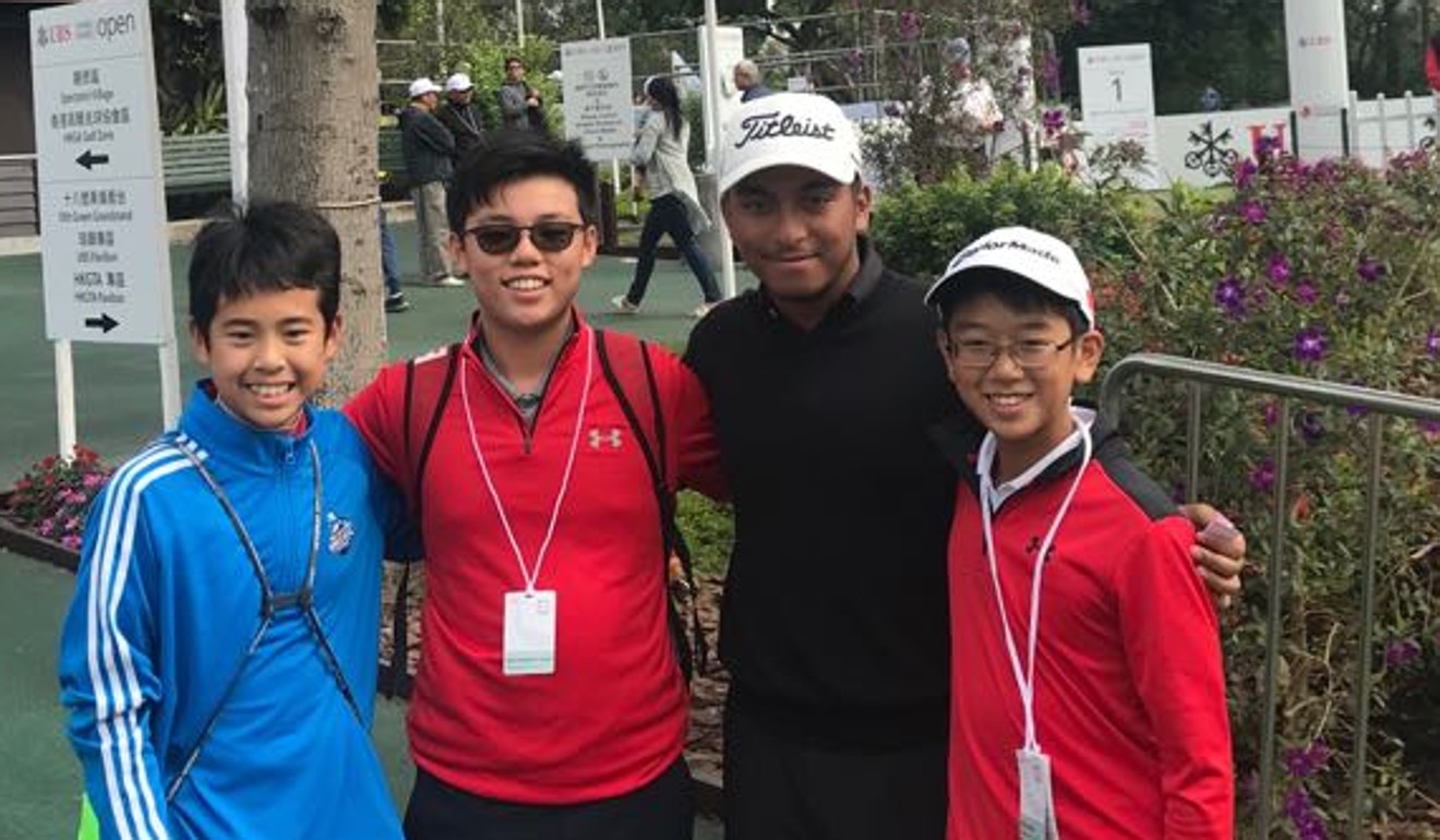 D'Souza poses with some young golf fans at Fanling.
