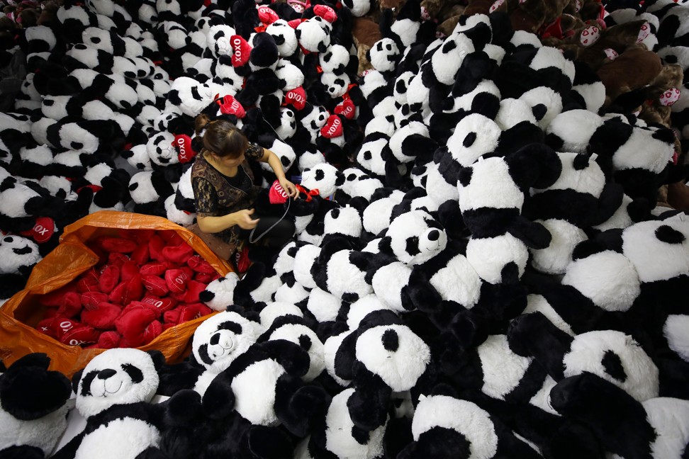 This photo taken on October 9, 2017 shows a Chinese employee making stuffed panda toys as they are prepared to export for the upcoming Christmas festive season, at a toy factory in Lianyungang in China's eastern Jiangsu province. Photo: AFP