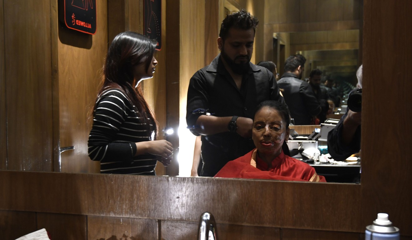 Indian acid attack survivor and model Anupanra has her hair done before the fashion show. Photo: AFP