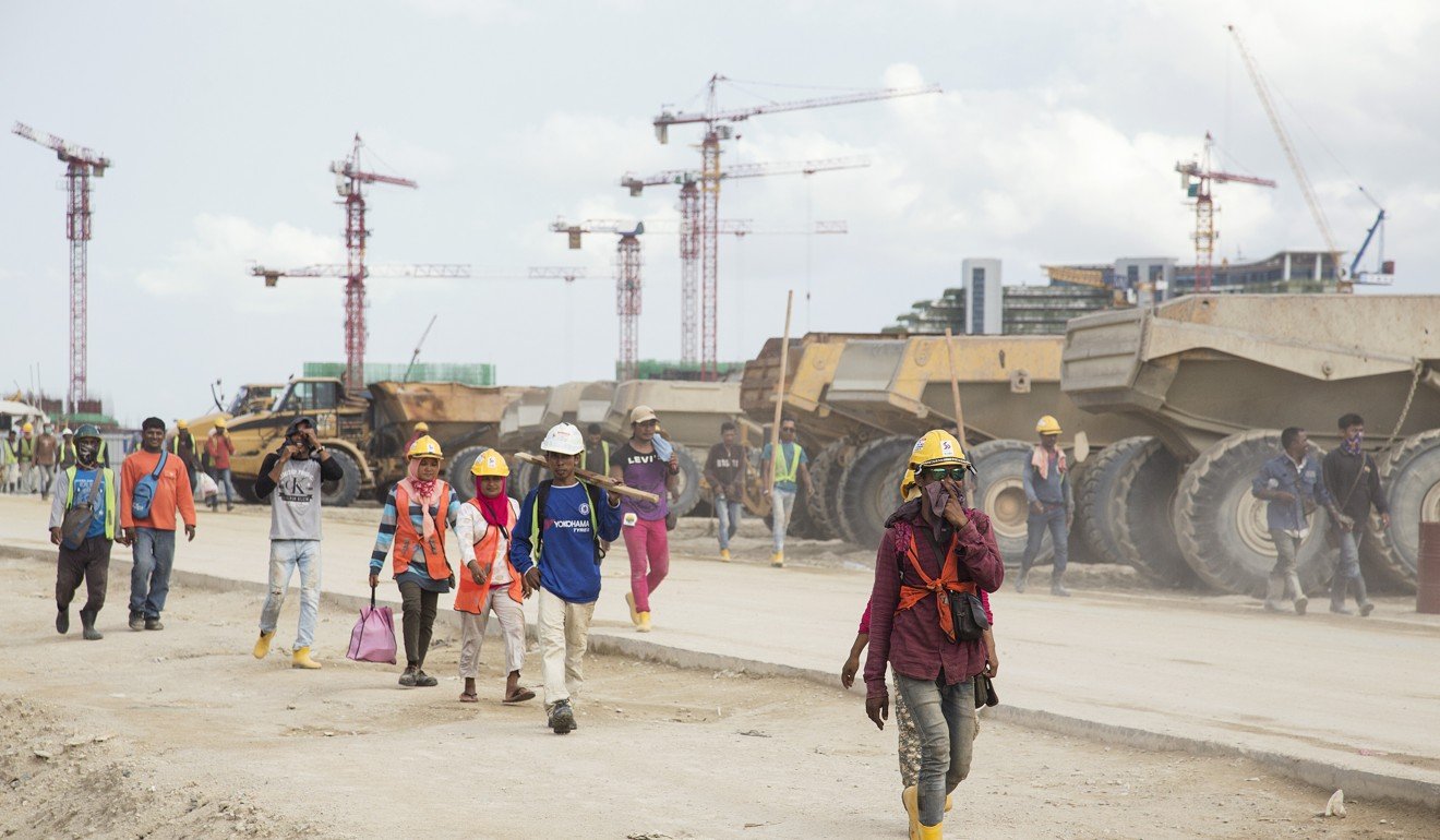 Workers leave for home after a day’s work at the Forest City development in Johor, Malaysia in July. Photo: Edward Hurstą