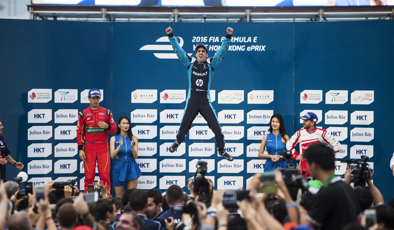 Sebastien Buemi jumps for joy on the podium after winning in Hong Kong.
