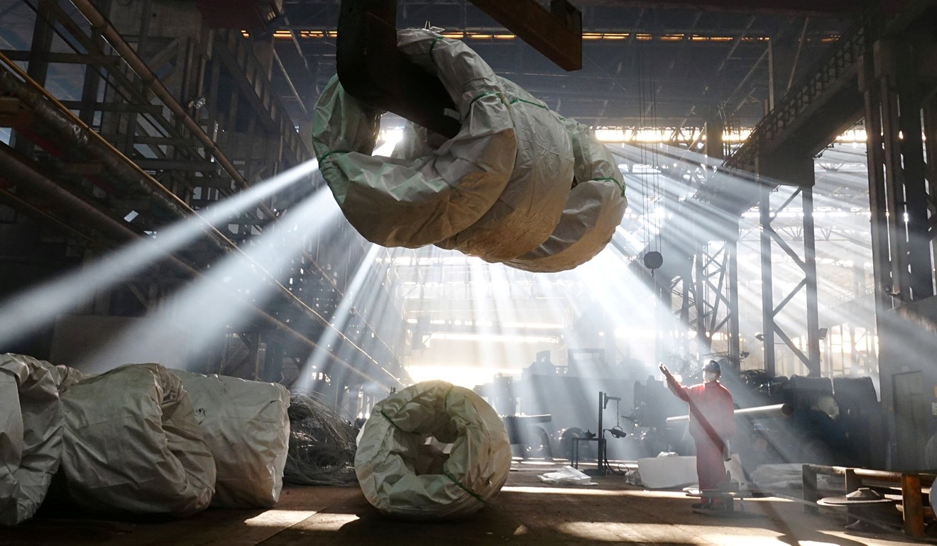 A worker directs a crane lifting steel wires at a factory of Dongbei Special Steel Group Co Ltd in Dalian, Liaoning province, China. Photo: Reuters