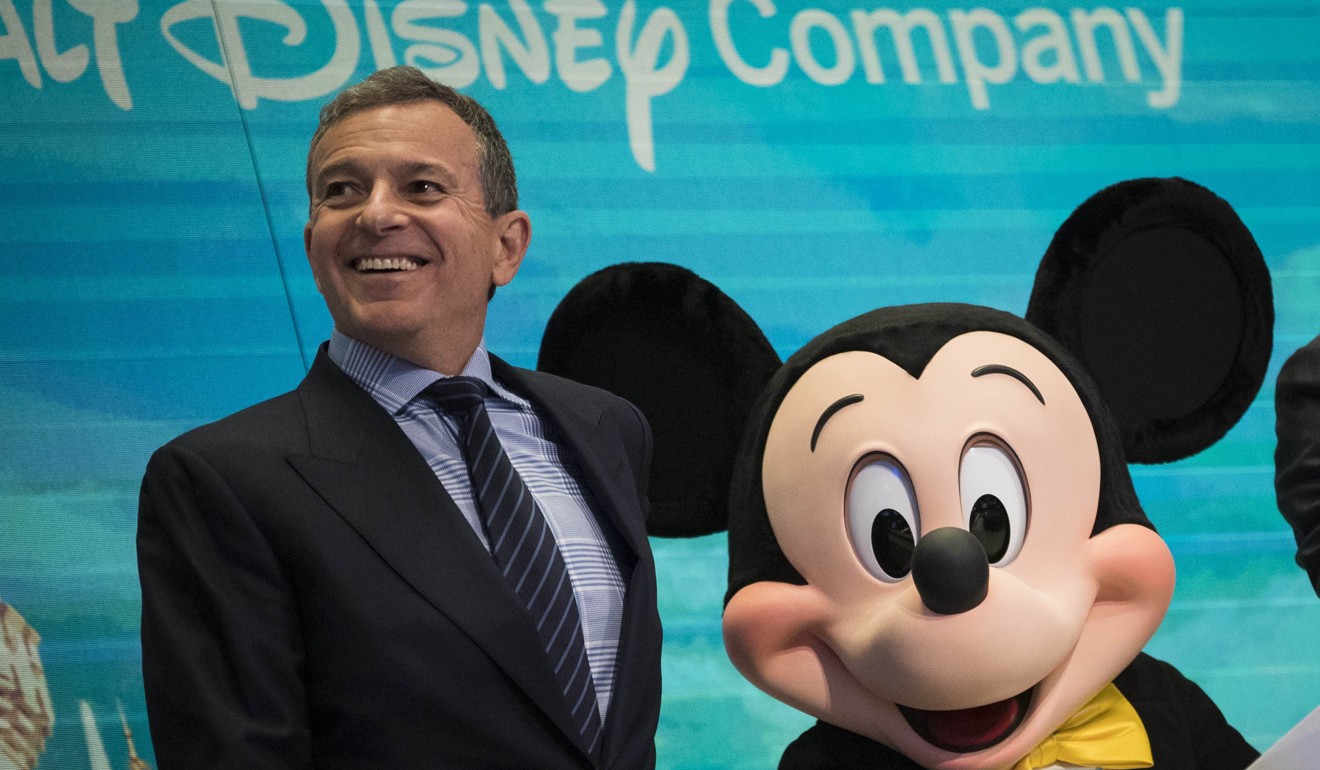 Chief executive officer and chairman of The Walt Disney Company Bob Iger and Mickey Mouse look on before ringing the opening bell at the New York Stock Exchangeon November 27. Photo: Agence France-Presse