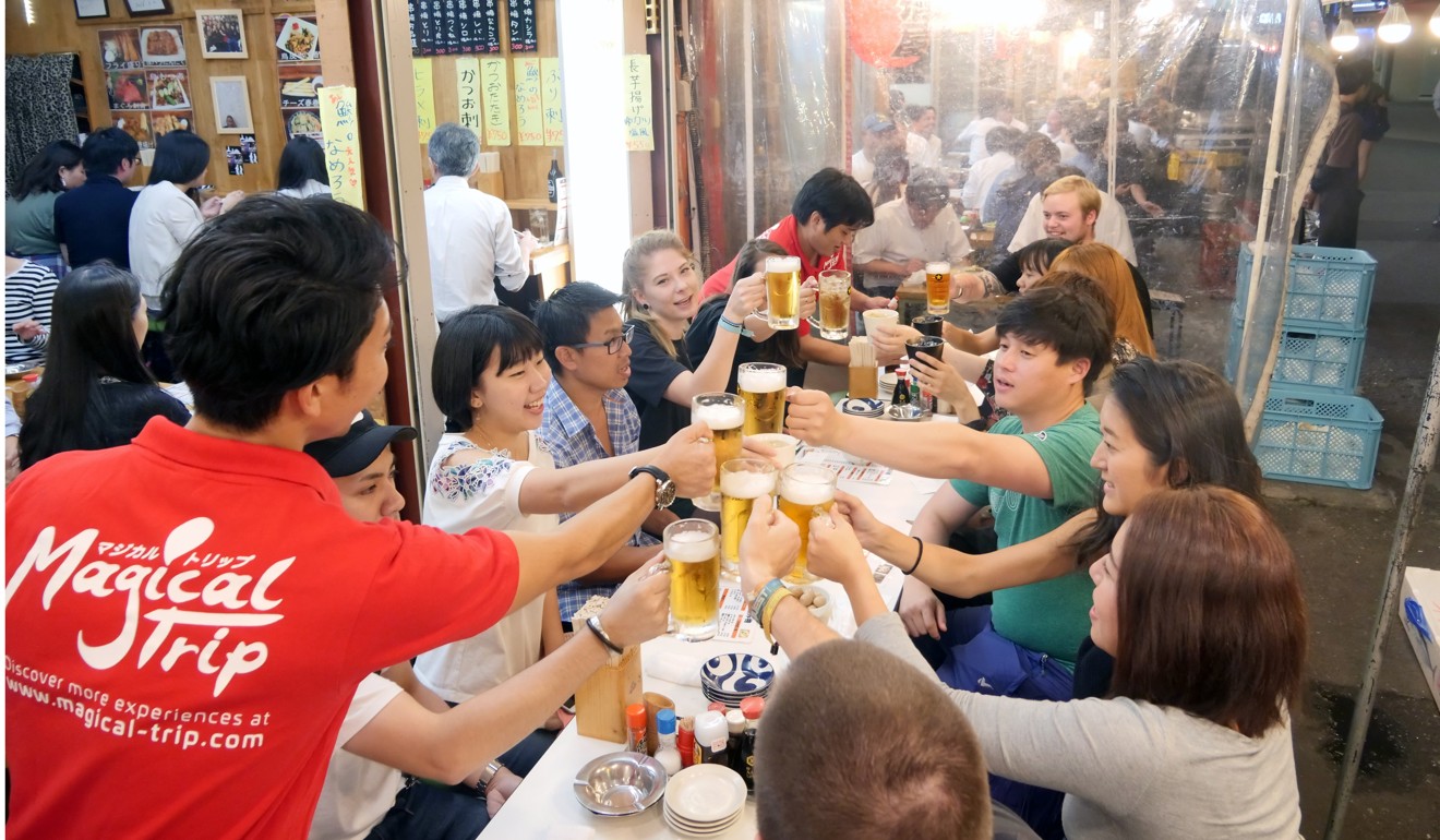 A guide leads a Magical Trip bar-hopping tour in the district of Asakusa.
