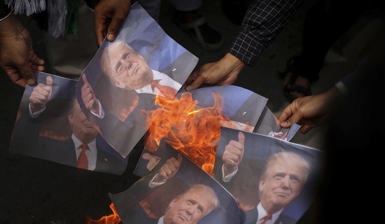 Portraits of Trump are burned during a rally against his decision to recognise Jerusalem as Israel's capital in Banda Aceh in Indonesia. Muslims across the world staged protests over the policy shift on the contested city. Photo: AP