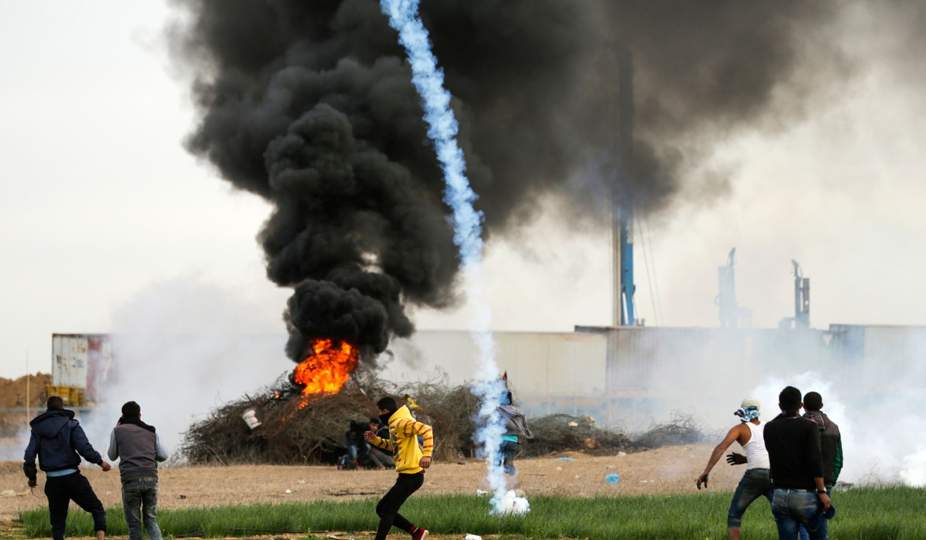 A tear-gas canister falls amid Palestinian protesters during clashes with Israeli forces near the Israel-Gaza border east of the southern Gaza strip city of Khan Yunis. New protests flared in the Middle East and elsewhere over US President Donald Trump's December 6 declaration of Jerusalem as Israel's capital. Photo: AFP