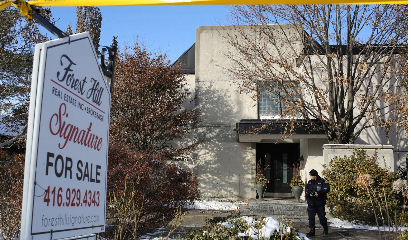 A police forensics photographer works outside the home of billionaire founder of Canadian pharmaceutical firm Apotex Inc, Barry Sherman and his wife Honey, who were found dead under circumstances that police described as suspicious in Toronto. Photo: Reuters