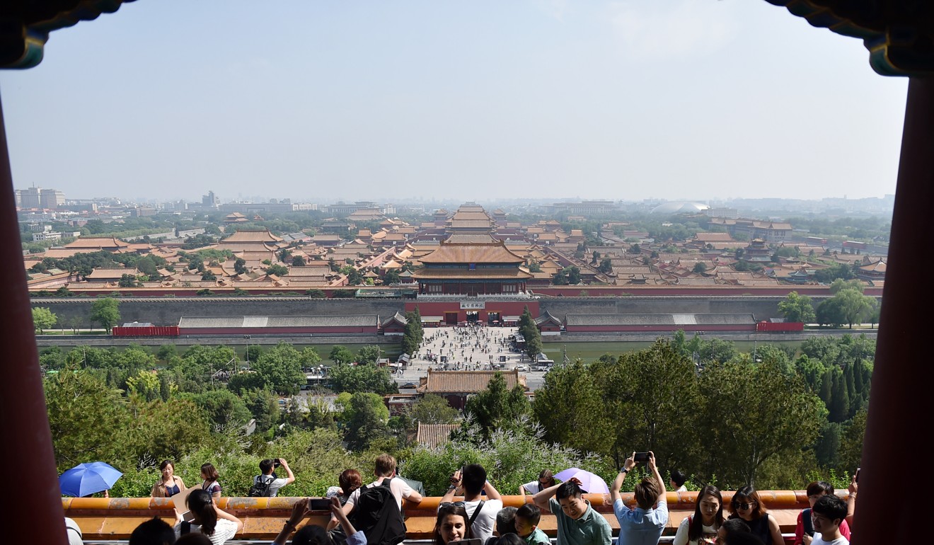 Tourists look at the Palace Museum in Jingshan Park, Beijing. Photo: Xinhua