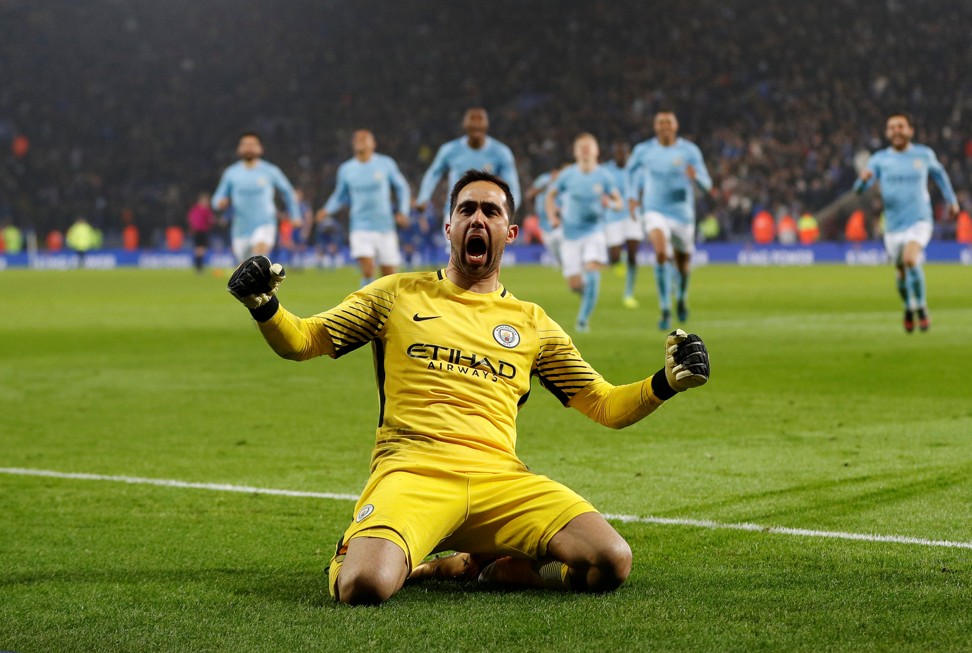 City keeper Claudio Bravo slides towards the fans after saving the decisive penalty. Photo: Reuters