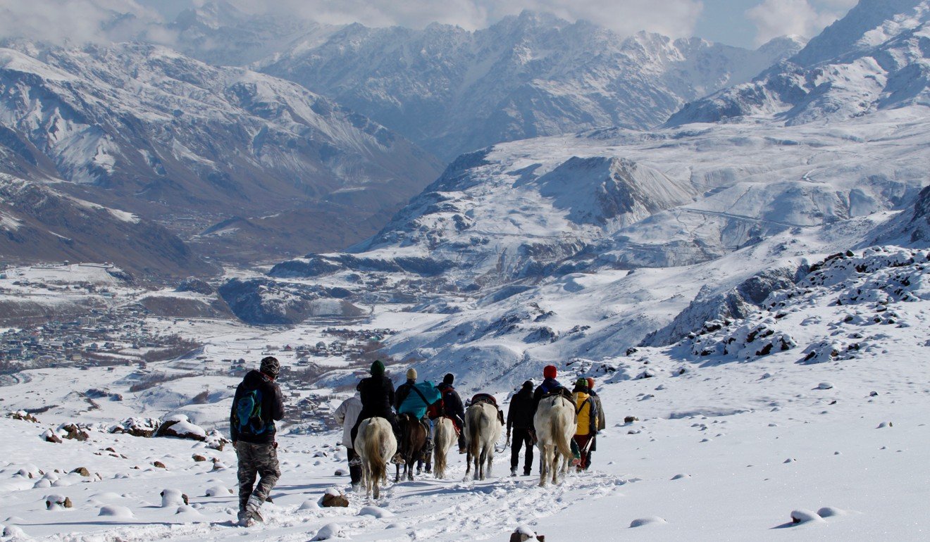The tour group descends from the mountain with mules loaded with equipment. Photo: Mark David Abbott