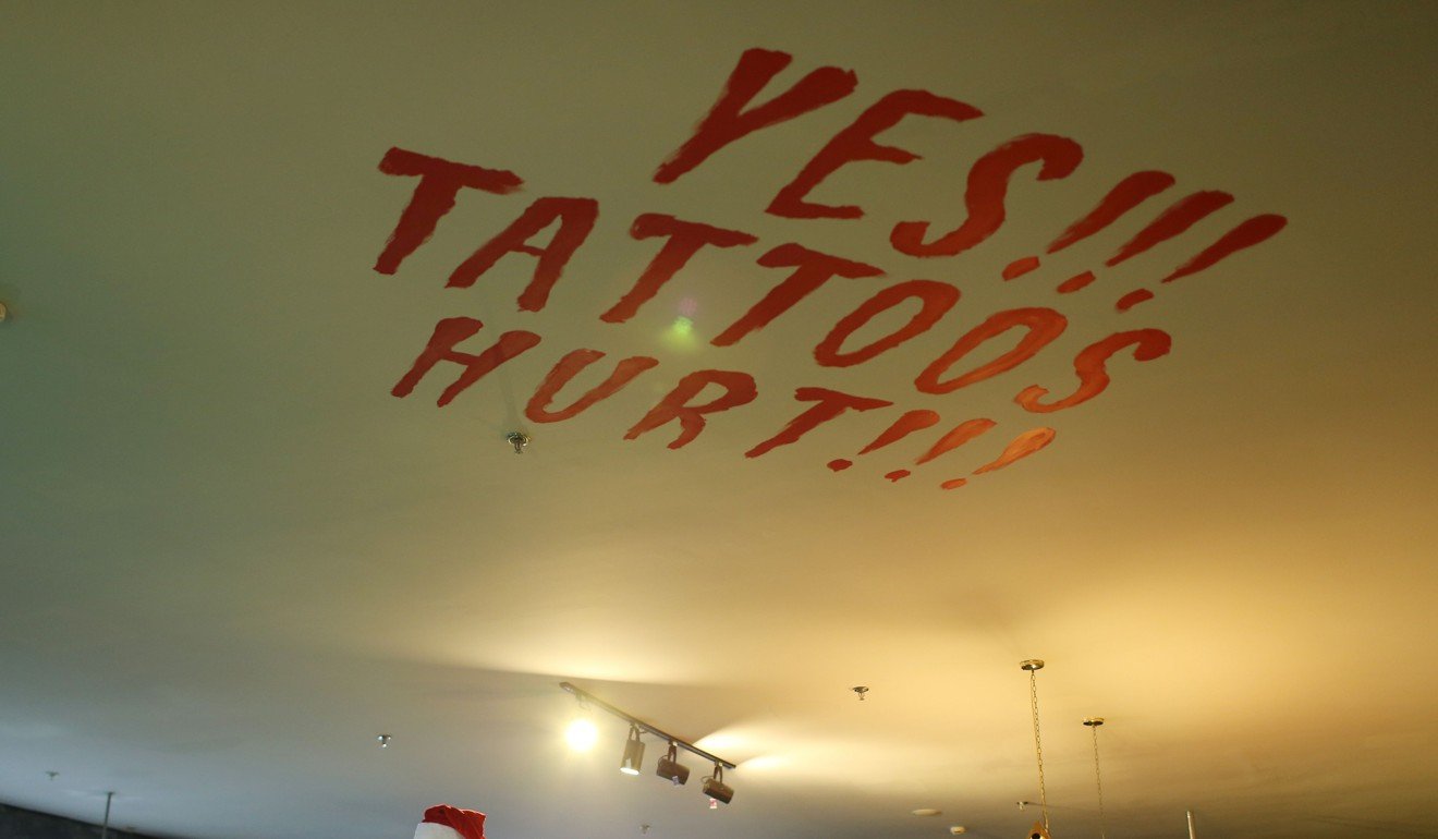 A sign painted on the ceiling of a tattoo studio in Shanghai. Photo: Agence France-Presse