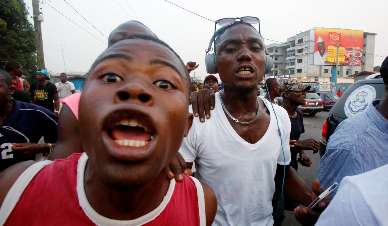 Supporters of George Weah celebrate after the announcement of the presidential election results. Photo: Reuters
