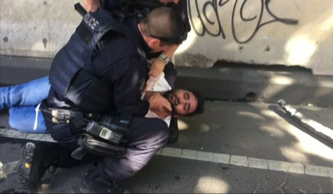 A man held by police after the car was driven into pedestrians. Photo: AP