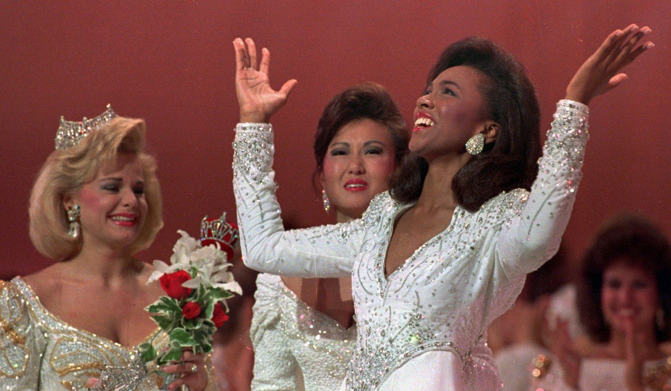 In this September 16, 1989, file photo, Miss America 1989 Gretchen Carlson, left, and first runner up Virginia Cha look on as Miss America 1990 Debbye Turner of Missouri throws her arms up in the air after winning the title in Atlantic City. Photo: AP