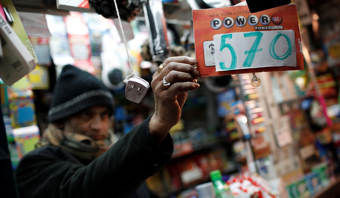 A vendor who sells lottery tickets hangs a sign for the Powerball draw. Photo: Reuters