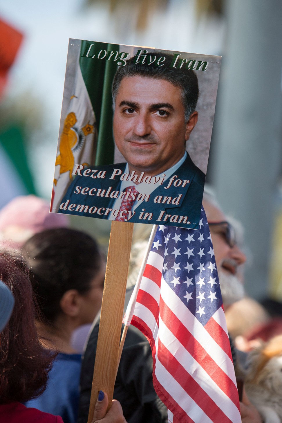 A placard with an image of Reza Pahlavi, the last heir apparent to the defunct throne of the Imperial State of Iran, is seen as thousands of people rally in support of Iranian anti-government protests in Los Angeles on Saturday. Photo: Reuters