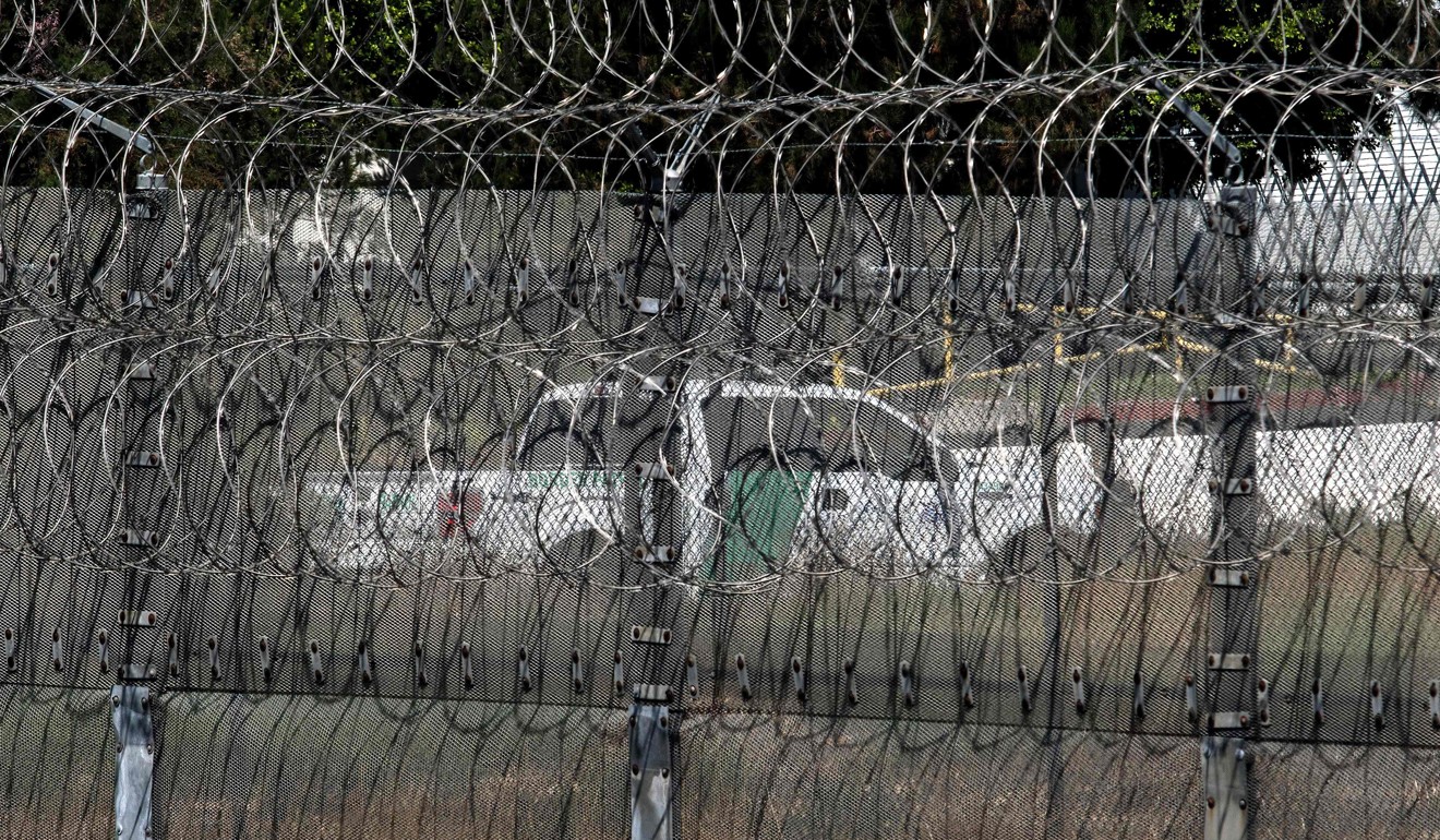 A Border Patrol vehicle is seen through the border fence near the exit of a tunnel used to smuggle people found at the US-Mexico border on August 27, 2017 in Tijuana. Photo: AFP