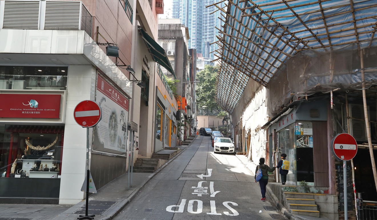 Hong Kong lacks barrier-free access for people with disabilities, forcing them to use the road instead. Photo: Nora Tam